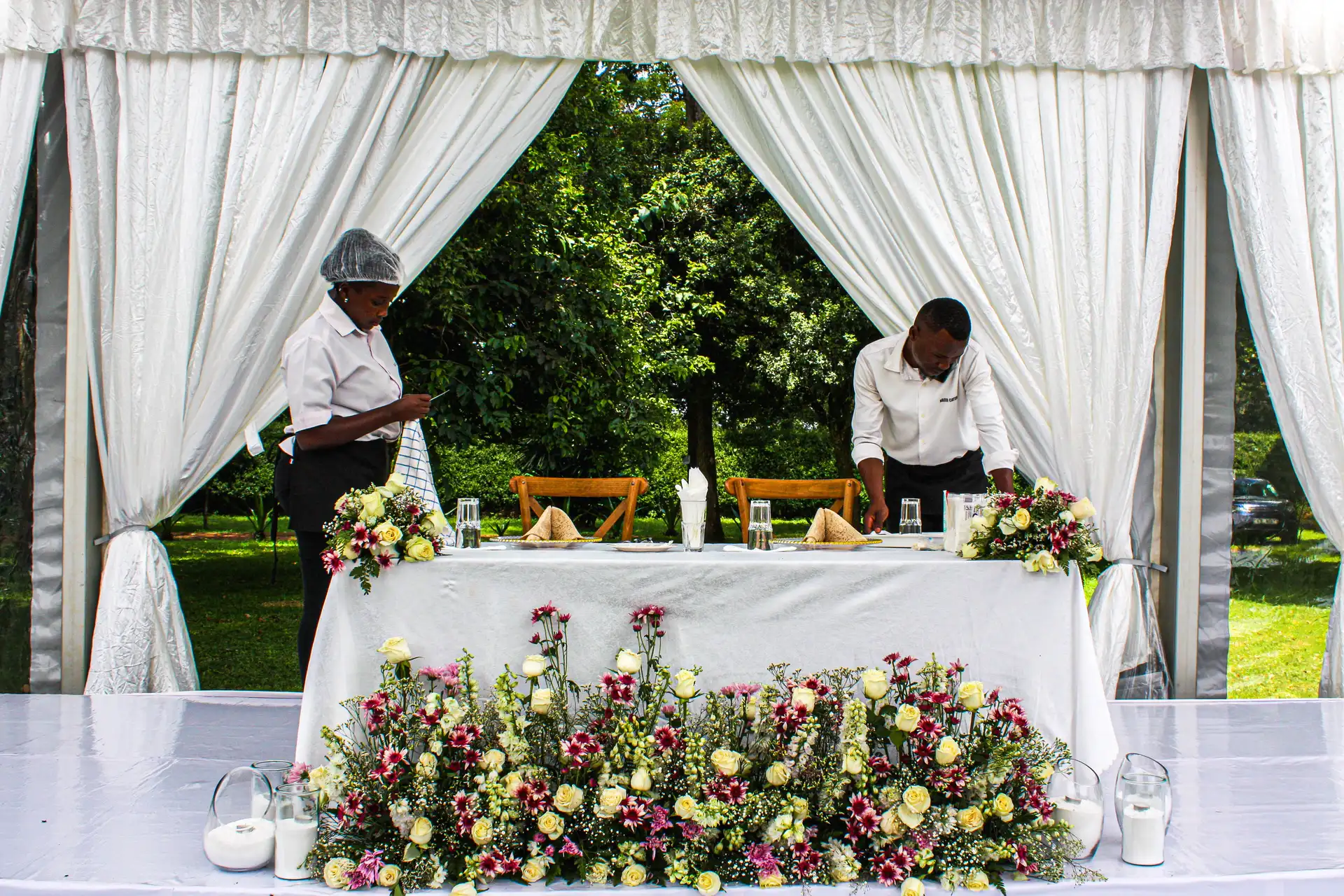 Nagira Catering team setting up a floral sweetheart table