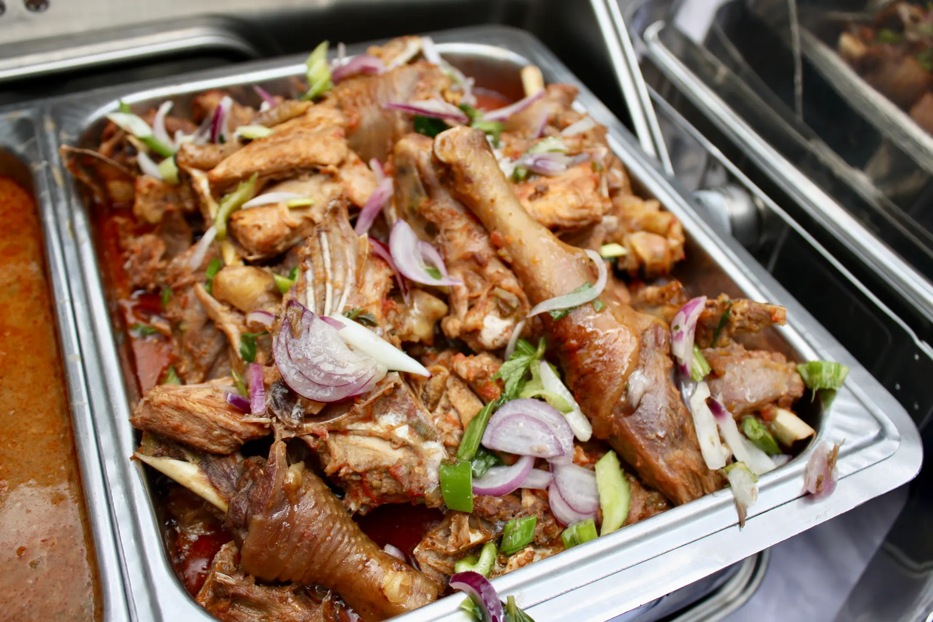 Roasted goat with red onion garnish